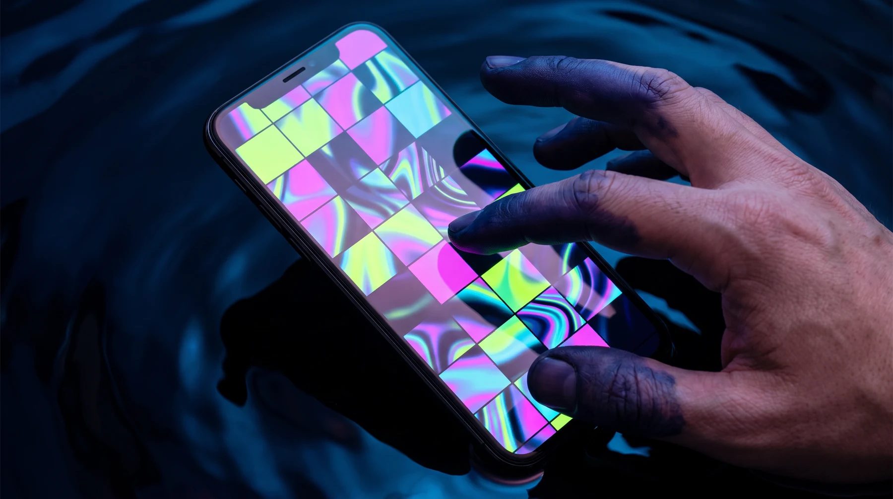 Hand testing an abstract colourful smartphone interface